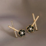geometric x shaped black camellia flower earrings