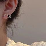 geometric x shaped black camellia flower earrings